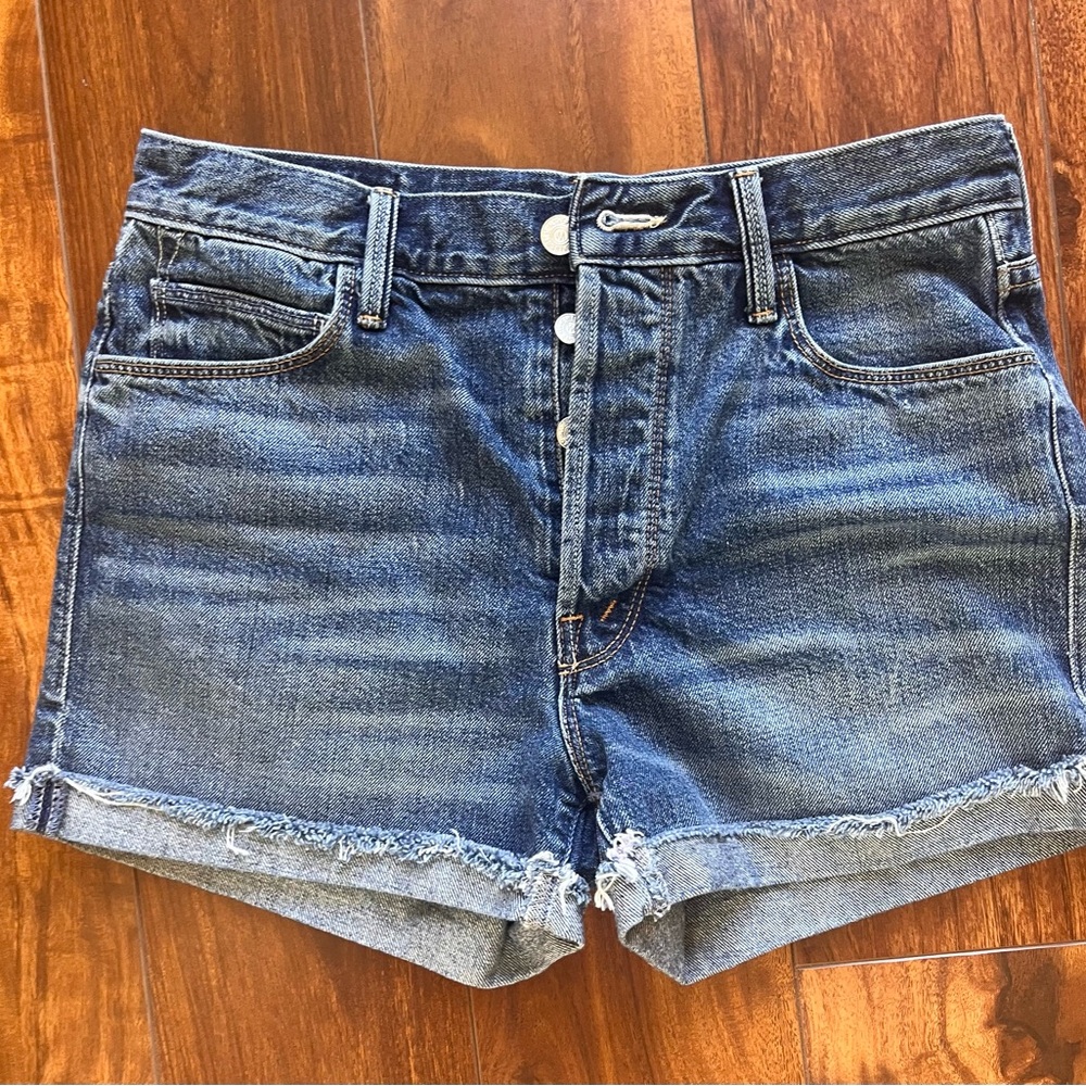 MOTHER Blue Jean Shorts with frayed rolled cuff. Button up.